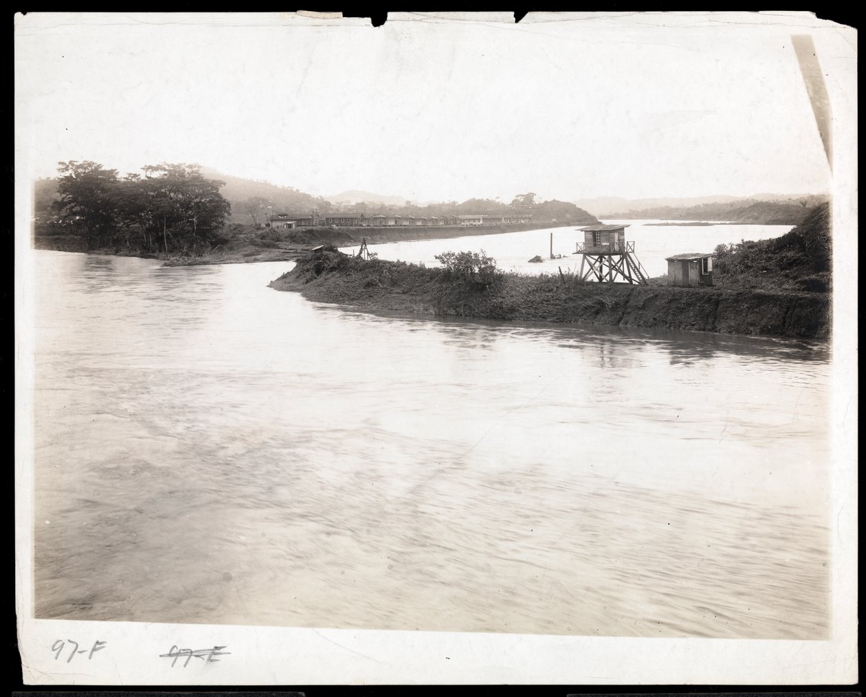 Ansicht des Wasserwegs während des Baus des Panamakanals mit vorgefertigten Arbeiterunterkünften im Hintergrund, 1912 oder 1913 von Byron Company