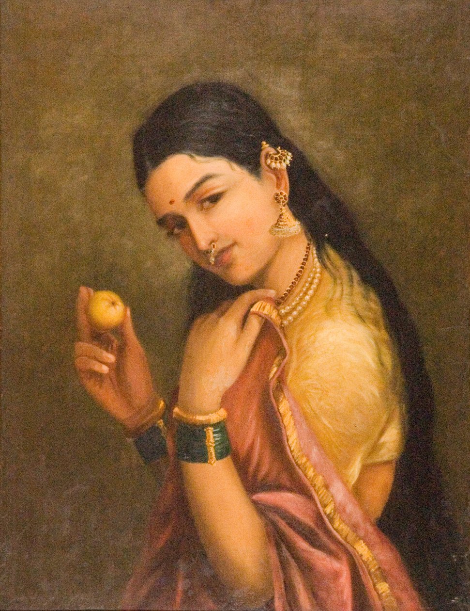 Frau hält eine Frucht von Raja Ravi Varma