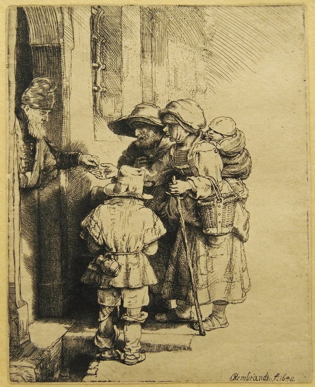 Ein blinder Drehorgelspieler und seine Familie erhalten Almosen von Rembrandt van Rijn